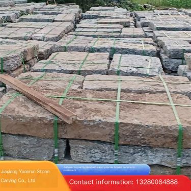 Irregular laying of old stone slabs in the pedestrian street of the old stone slab park